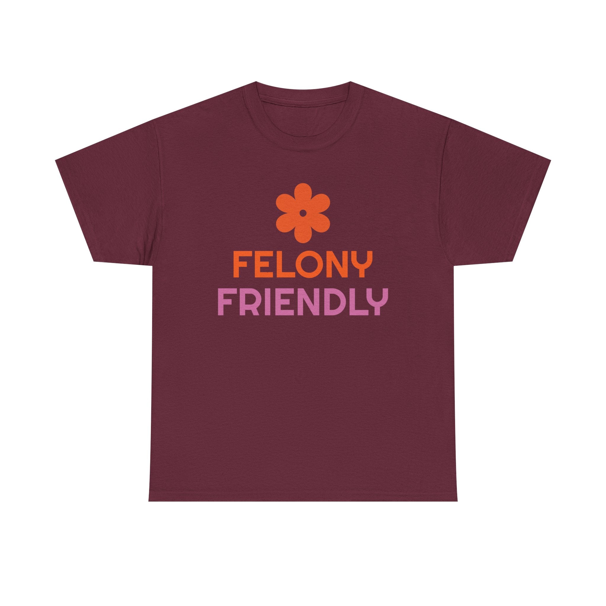 Maroon t-shirt with orange flower and pink text on a white background